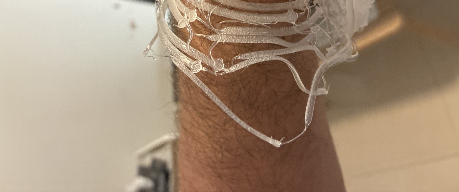 A translucent woven cuff, formed on a forearm while still warm